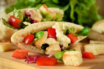 Caesar salad in pita bread on a wooden board