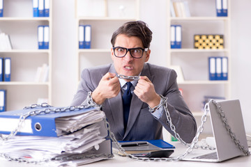 Busy employee chained to his office desk