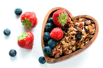 Healthy breakfast: homemade gramola with fresh blueberry and strawberry on white background