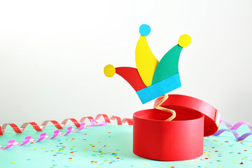 Box with surprise and confetti on table. April fool's day celebration