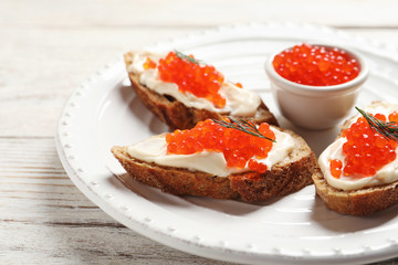 Sandwiches with red caviar on plate