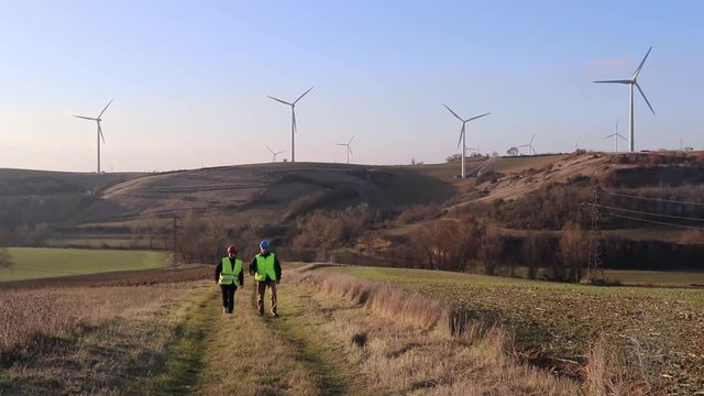 Team of worker male and female. Wind turbines.