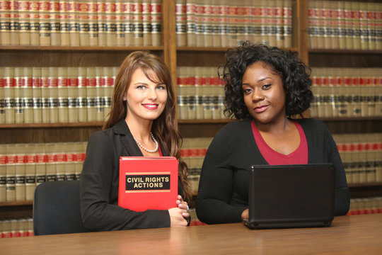 Women in work place, two women attorney in law library, civil rights lawyer
