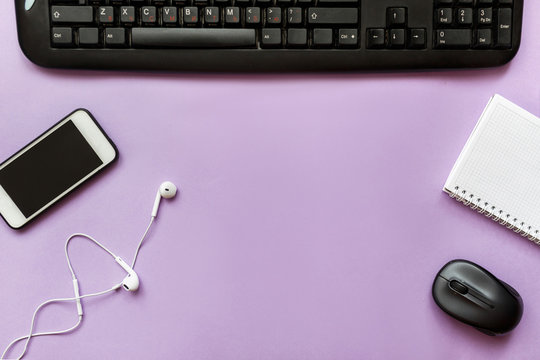 Modern workspace smartphone, notebook, tablet on violet color background. Top view. Flat lay style.