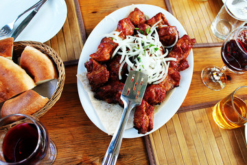 barbecue on a plate in the bar on the table