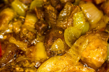 Roast meat, onions, carrots and spices, boiling in oil