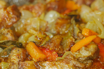 Roast meat, onions, carrots and spices, boiling in oil