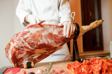 Professional cook making a delicious jamon on the table