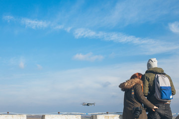 Naklejka premium Two couple taking a selfie with a drone, drone navigating
