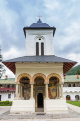 Fototapeta na wymiar Front of the little white church of the monastery in Sinaia, Romania