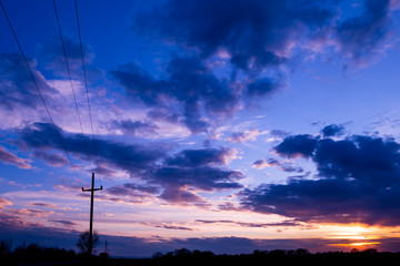 Vivid color clouds on sunset  landscape.  Blue sky with bright pink, yellow and purple