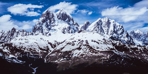 Panoramic view of the Caucasus mountains covered with snow including a famous horned peak Ushba (4690 m). Svaneti region, Georgia.