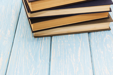 Naklejka na ściany i meble pile of old books on wooden background