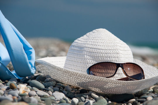Hat, bag, and glasses on beach