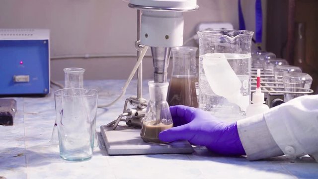Scientist's hands mixing the sample
