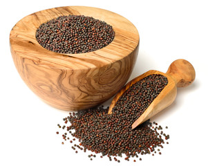 dried canola seeds in the olive wooden mortar, isolated on white