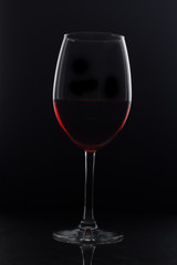 glass of red wine on black background