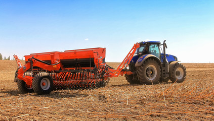 modern combine harvester works in the field. Sowing and harvesting.
