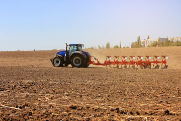 modern combine harvester works in the field. Sowing and harvesting.