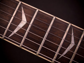 Detail of fingerboard and strings of vintage electric Guitar