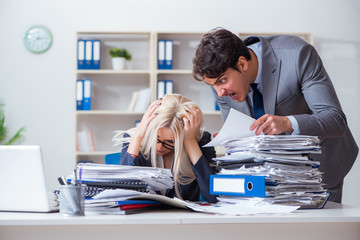 Angry irate boss yelling and shouting at his secretary employee