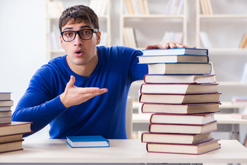 Male student preparing for exams in college library