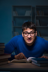 Student preparing for exams late at night in library