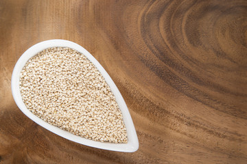 Organic quinoa seeds in the bowl and spoon