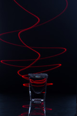 glass of tequila with salt with red light