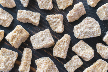 Brown sugar on the wooden background