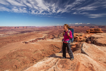 Hiker rests in Canyonlands National park in Utah, USA