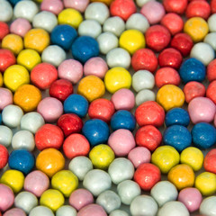 Background of small round multi-colored sweets.