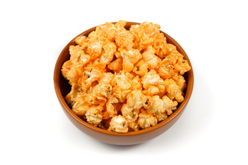 delicious , spicy popcorn in a clay brown plate on a white background
