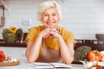Portrait of a beautiful elderly woman in the kitchen after cooking