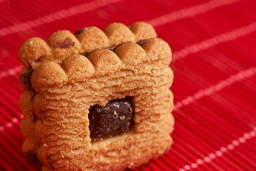 Stacked chocolate chip cookies on style red table