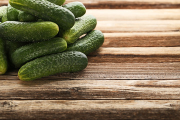 Fresh cucumbers on brown wooden table