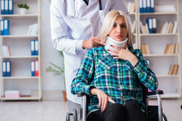 Disabled woman in wheel chair visiting man doctor