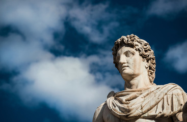 Ancient marble statue of Castor or Pollux, dated back to the 1st century BC, located at the top of monumental balustrade in Capitoline Hill, in Rome (among clouds)