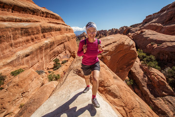 Hiker rests in Arches National park in Utah, USA