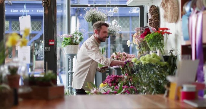 Small business owner using digital tablet in a florist