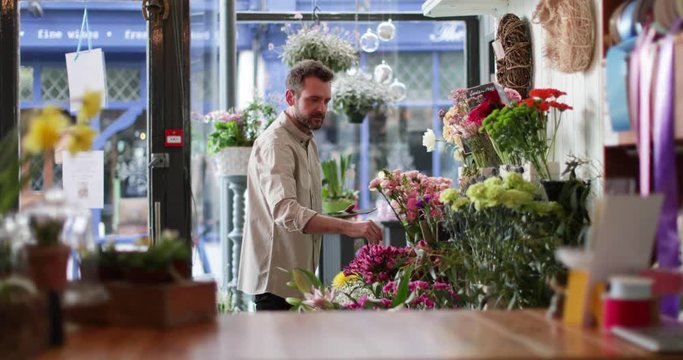 Portrait of a small business owner using digital tablet in a florist