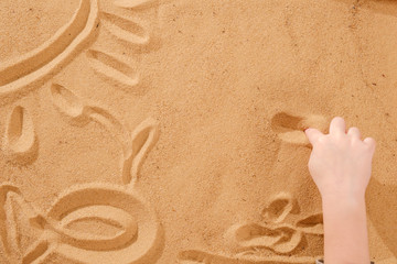 Sand therapy, child's hands are painted on table with sand