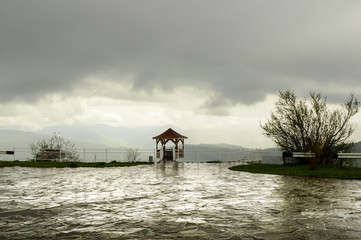 Area with gazebo with views of the mountains in the rain. Caucasus.