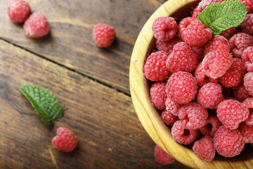 Fresh raspberry in a wooden plate