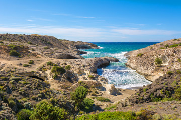 Kapros, small bay between rocks and blue sea on Milos island. Cyclades, Greece.