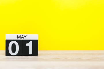 May 1st. Day 1 of may month, calendar on business office table, workplace at yellow background. Spring time. International Workers' Day