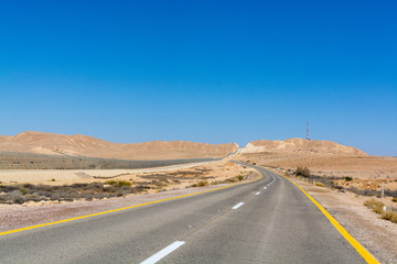 Fototapeta na wymiar Asphalt road in desert Negev, Israel, road 40, transport infrastructure in desert, scenic mountains route from Eilat to north of Israel