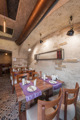 Setting tables in rustic styled restaurant interior