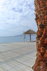 Beautiful public sandy beaches on Red Sea in Eilat with stro umbrellas, luxury vacation spa resorts in Israel