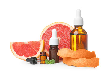 Composition with grapefruit essential oil on white background